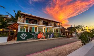 a building with a mural on the side of the street at Hotel Villa de Pescadores in Río Lagartos