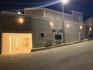 a building with a door on the side of it at night at ستديو in Al Baha