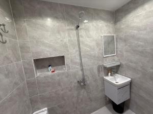 a bathroom with a shower with a toilet and a sink at ستديو in Al Baha
