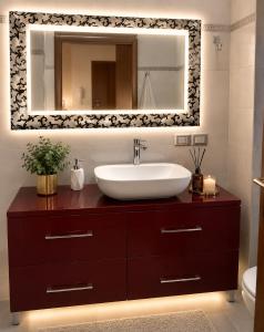 a bathroom with a sink and a mirror at Morgan's oasis in San Felice del Benaco