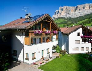 an aerial view of a house with mountains in the background at Apartments Lasteis in La Villa