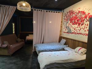 a bedroom with two beds and a painting on the wall at kyoto b&b in Ostend