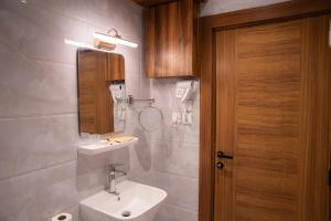 a bathroom with a sink and a mirror and a toilet at H SAM Hotel in Taif +58 photos