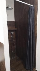 a bathroom with a shower with a shower curtain at Tami Apartman Hviezdoslavova 2, Liptovsky Mikulas, Private Parking in Liptovský Mikuláš