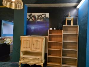 a room with a dresser and a tv at kyoto b&b in Ostend