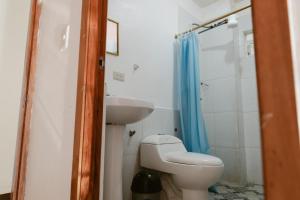 a bathroom with a toilet and a sink at PELICAN TOURS in Puerto Baquerizo Moreno