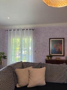 a living room with a couch and a window at Casa Cataleia VILLA INN in Ponte de Lima +55 photos