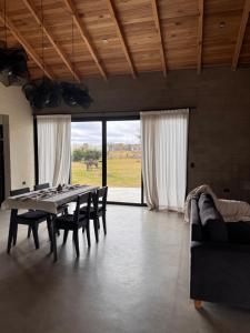 a dining room with a table and chairs and a couch at Entre Paz y Enfoque in Luján