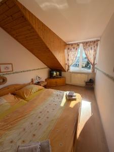 a bedroom with a large bed in a attic at Pizzerie Osičko in Bystřice pod Hostýnem
