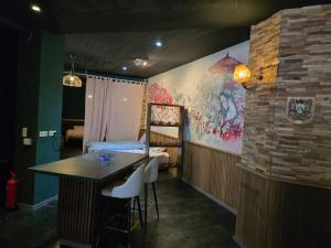 a room with a table and a bedroom with a bed at kyoto b&b in Ostend