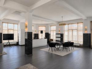 a large living room with a table and chairs at White House Meerane - Loft Sky in Meerane