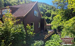 a small house in the middle of a forest at Arode Alte Schmiedemühle in Zorge