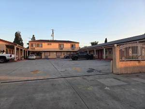 an empty parking lot in front of some buildings at Evans Motel in Maywood +13 photos