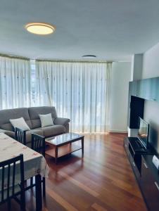 a living room with a couch and a table at apartamento victor in Cee