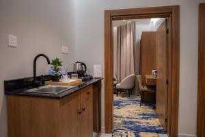 a kitchen with a sink and a counter top at H SAM Hotel in Taif