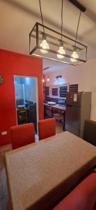 a kitchen and dining room with a table and chairs at Altos Aparts cabañas in Estancia Vieja