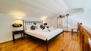 a bedroom with a bed and a wooden floor at oleabungalows in Akrotiri +47 photos