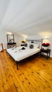 a large bed in a room with a wooden floor at oleabungalows in Akrotiri