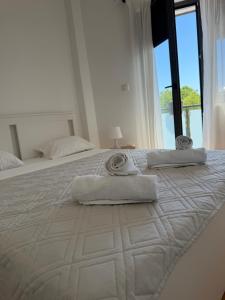 a large white bed with two towels on it at Apartman Petrovic in Vranje