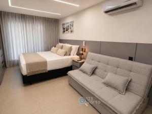 a hotel room with a bed and a couch at Emunah by 123Quarto in Camalaú +92 photos