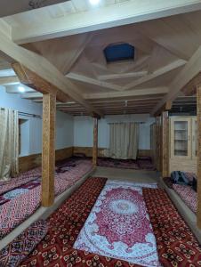 a room with a large rug on the floor at Passu Didargah Resort in Pasu