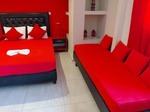a red bedroom with a red bed and red pillows at Apartments Vesna Luxury & Michel ap 8 in Paralia Katerinis