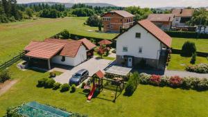 an aerial view of a house with a playground at Soba i Apartman Đula in Ogulin