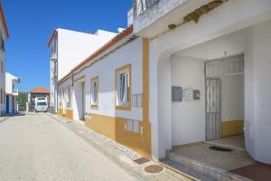 a row of white buildings on a street at Casa Lotus in Aljezur