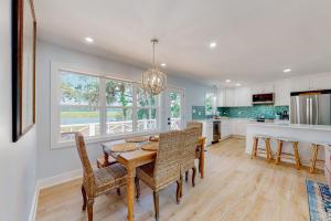 a kitchen and dining room with a table and chairs at The Toasted Oyster in Edisto Island