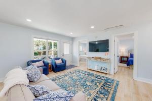 a living room with a couch and blue chairs at The Toasted Oyster in Edisto Island