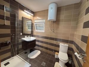 a bathroom with a toilet and a sink and a mirror at Villa Pontem in Komarna +26 photos