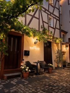 a table and chairs sitting outside of a building at MiTi Sleep and Go in Bernkastel-Kues