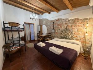 a bedroom with a bed and a brick wall at La Dimora del Grano in Rignano Garganico