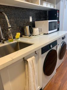 a kitchen with a sink and a microwave at Arkona Home in Toronto