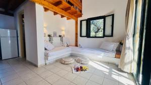 a living room with a couch and a table at oleabungalows in Akrotiri