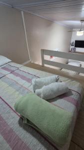 a bed with two pillows on it in a room at Loft Caminho do Mar in Angra dos Reis