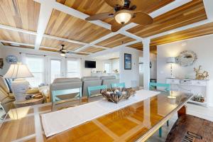 a living room with a couch and a ceiling fan at KC's Seaside Sanctuary in Edisto Island