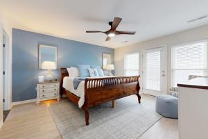 a bedroom with a bed and a ceiling fan at KC's Seaside Sanctuary in Edisto Island +15 photos