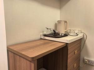 a kitchen with a counter with a coffee maker on it at Motel Schmotel in Brighton & Hove