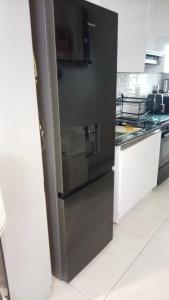 a kitchen with a stainless steel refrigerator at NewAge Smart 2 in Ikeja +2 photos