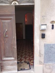 an open door to a hallway with a tile floor at Borgo antico Pisa in Montecastello
