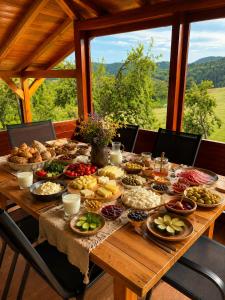 a table with a bunch of food on it at Davidovic House in Amzići