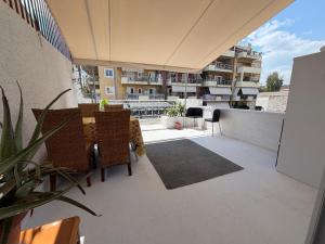 a balcony with a table and chairs on a building at Piraeus Sea Loft in Piraeus
