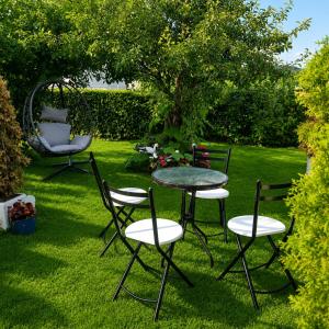 a table and chairs in a yard with a table and chairs at Peđa in Ogulin
