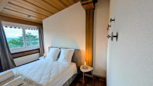 a bedroom with a bed with a window and a table at Chillon lake view by MK in Montreux