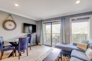 a living room with a table and a clock on the wall at HH Beach & Tennis 226C in Hilton Head Island