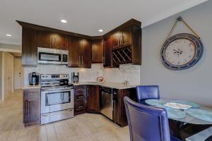 a kitchen with a table and a clock on the wall at HH Beach & Tennis 226C in Hilton Head Island