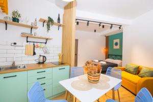 a kitchen and living room with a table and chairs at M Boutique Aparthotel in Tbilisi City