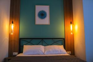a bedroom with a bed with two lights on it at M Boutique Aparthotel in Tbilisi City