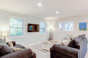a living room with two couches and a table at Barefoot Lizzy's in Edisto Island